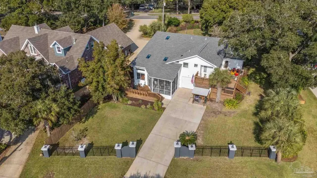 an aerial view of a house with outdoor space and lake view