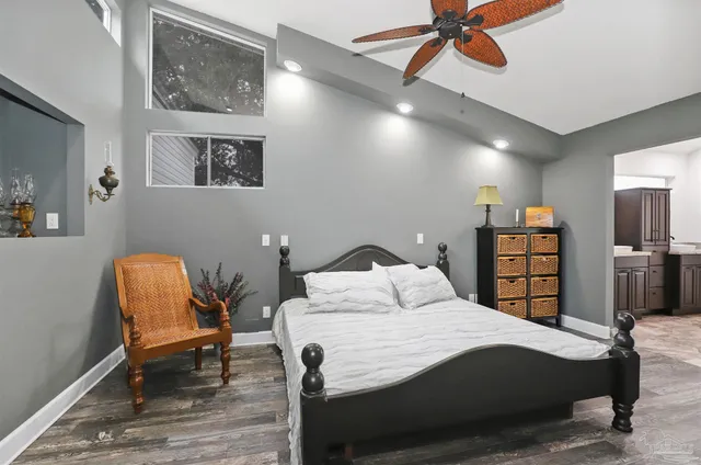 a bedroom with a bed a desk and chair