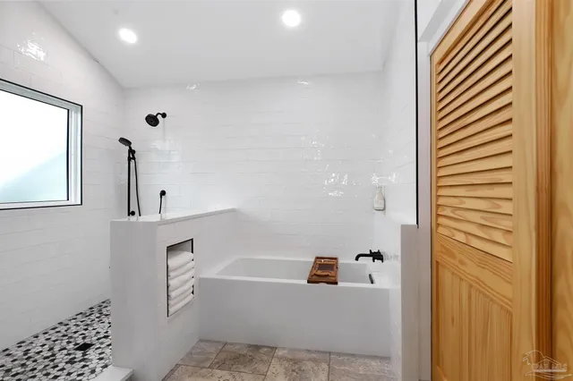 a bathroom with a bathtub and a shower