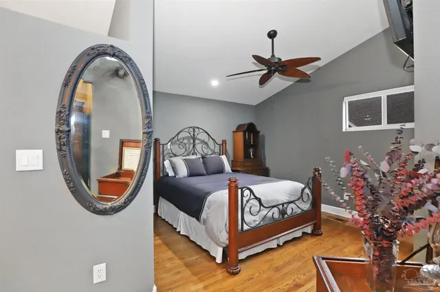 a bedroom with bed and a chandelier