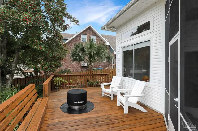 a view of a deck with wooden floor and outdoor seating