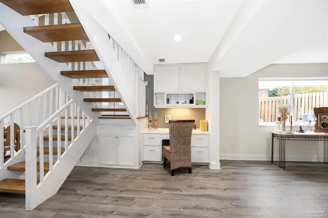 a view of a kitchen with furniture and staircase