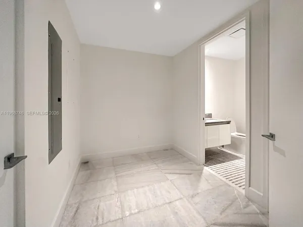 a bathroom with a granite countertop double vanity sink and mirror with shower