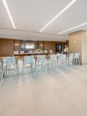 a lobby with furniture and floor to ceiling window