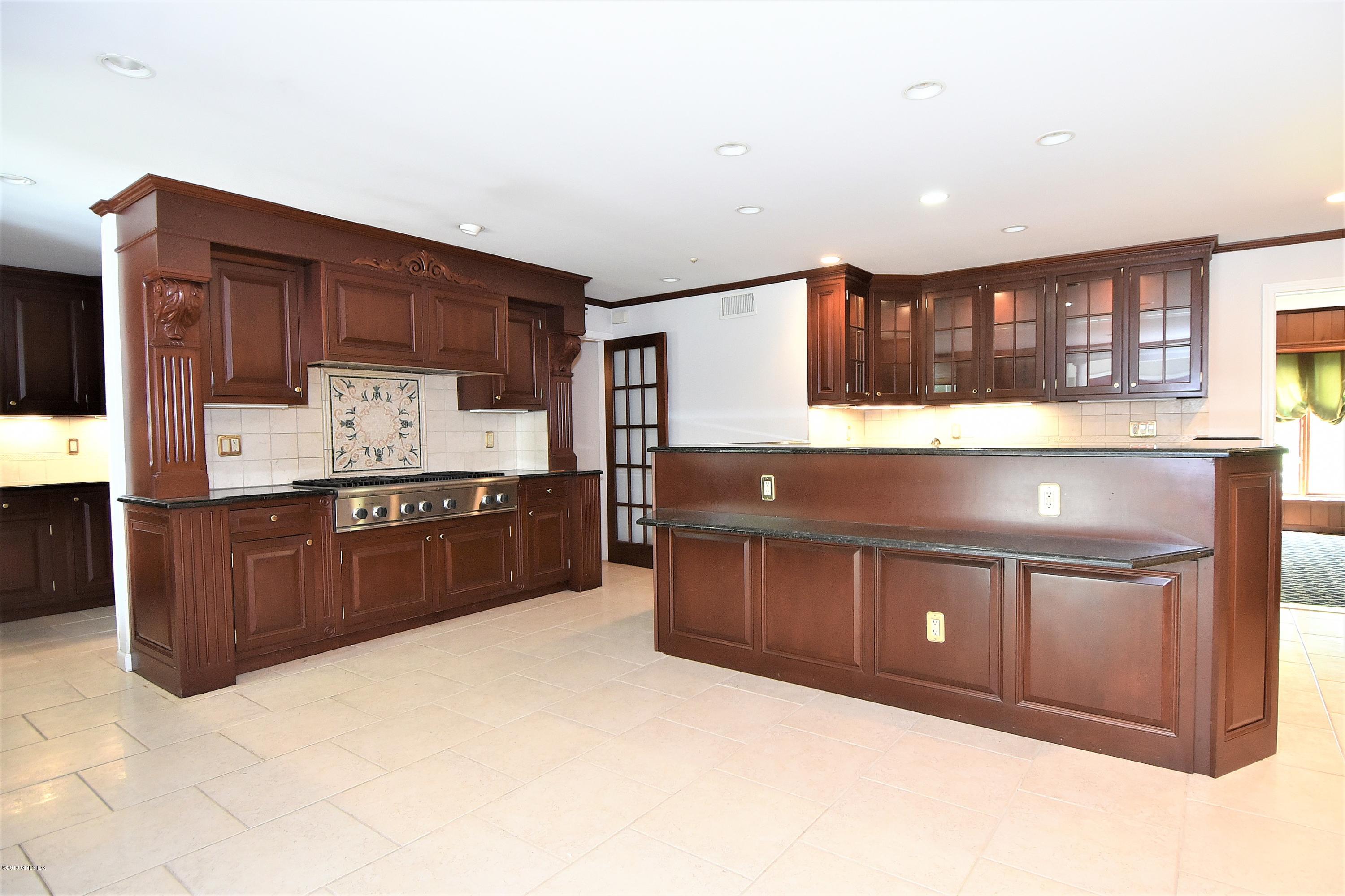 1 Tinker Lane Greenwich, CT 06830 - Photo 11 of 30 a kitchen with stainless steel appliances granite countertop a stove and a refrigerator