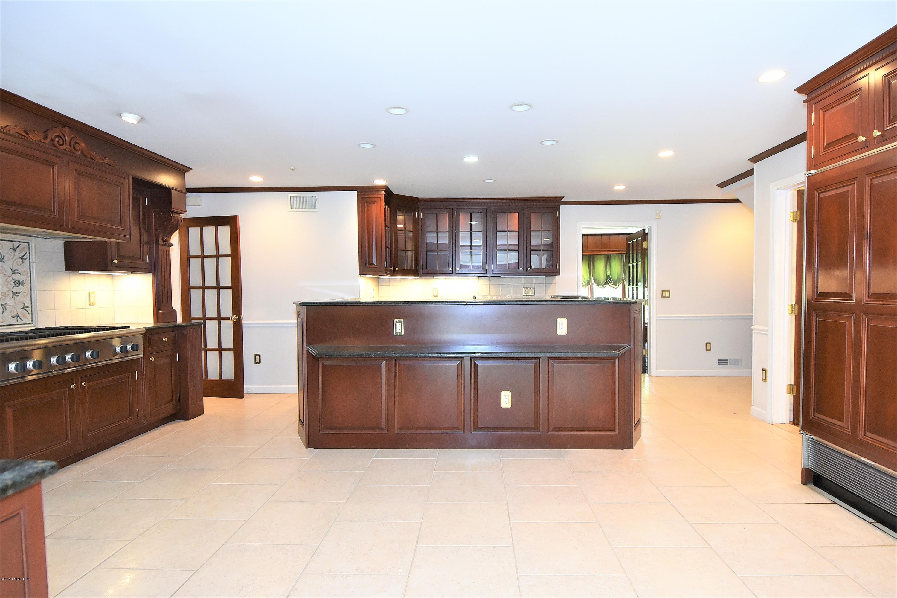 1 Tinker Lane Greenwich, CT 06830 - Photo 14 of 30 a kitchen with stainless steel appliances a refrigerator and a stove top oven