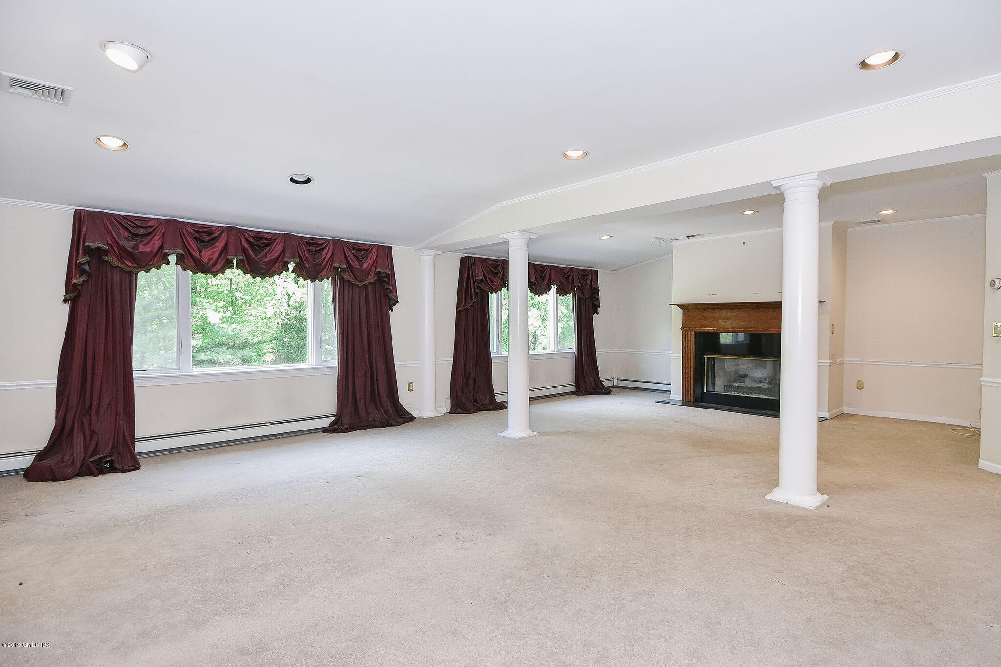 1 Tinker Lane Greenwich, CT 06830 - Photo 18 of 30 an empty room with furniture and a fireplace