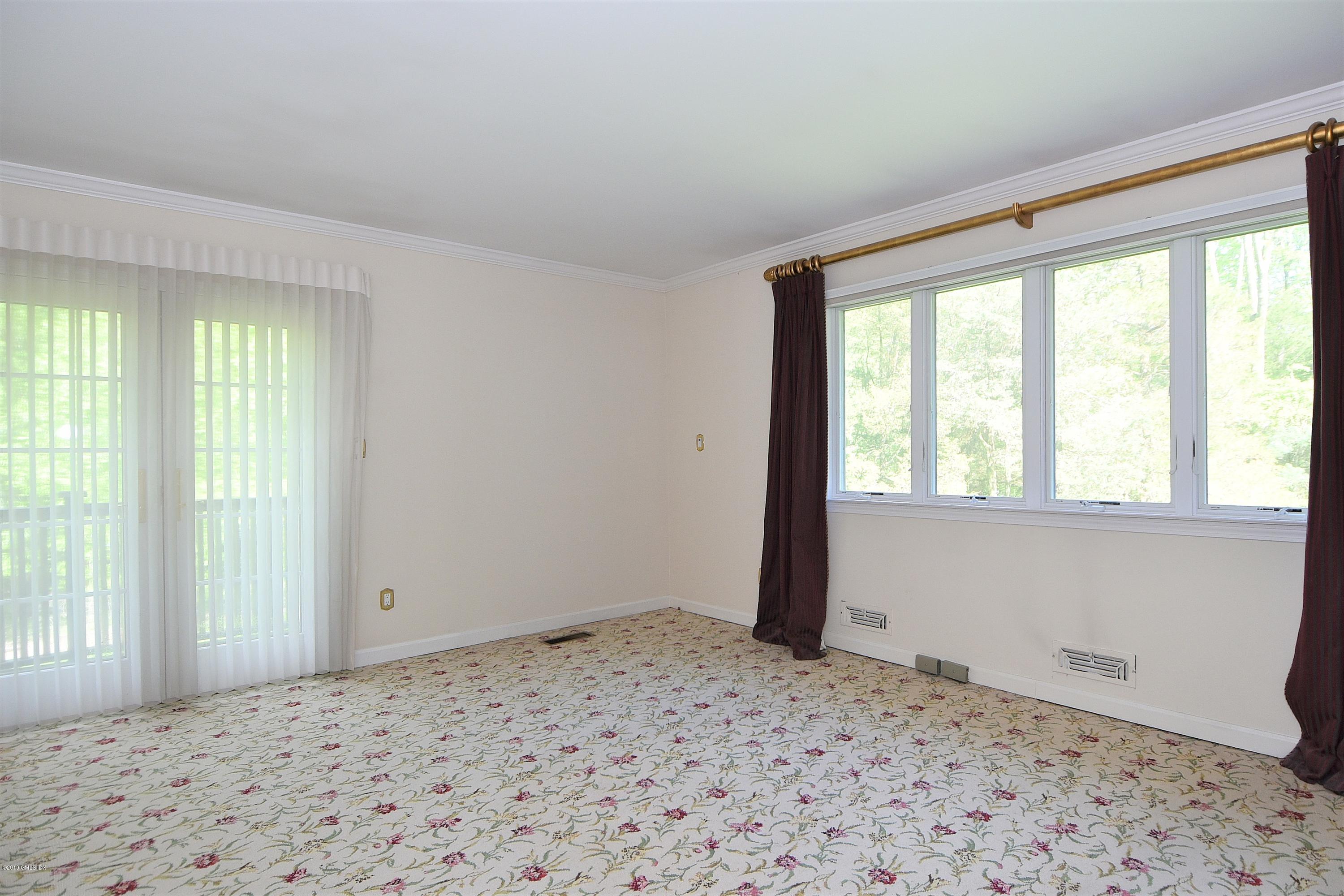 1 Tinker Lane Greenwich, CT 06830 - Photo 22 of 30 a view of a big room with wooden floor and windows