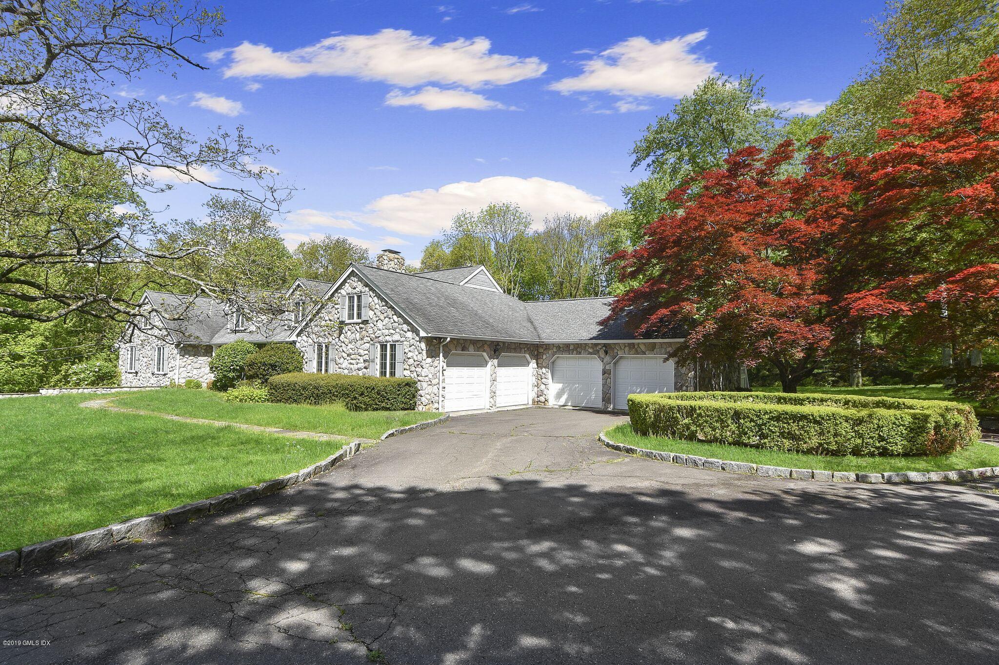1 Tinker Lane Greenwich, CT 06830 - Photo 27 of 30 a front view of a house with a yard and outdoor seating