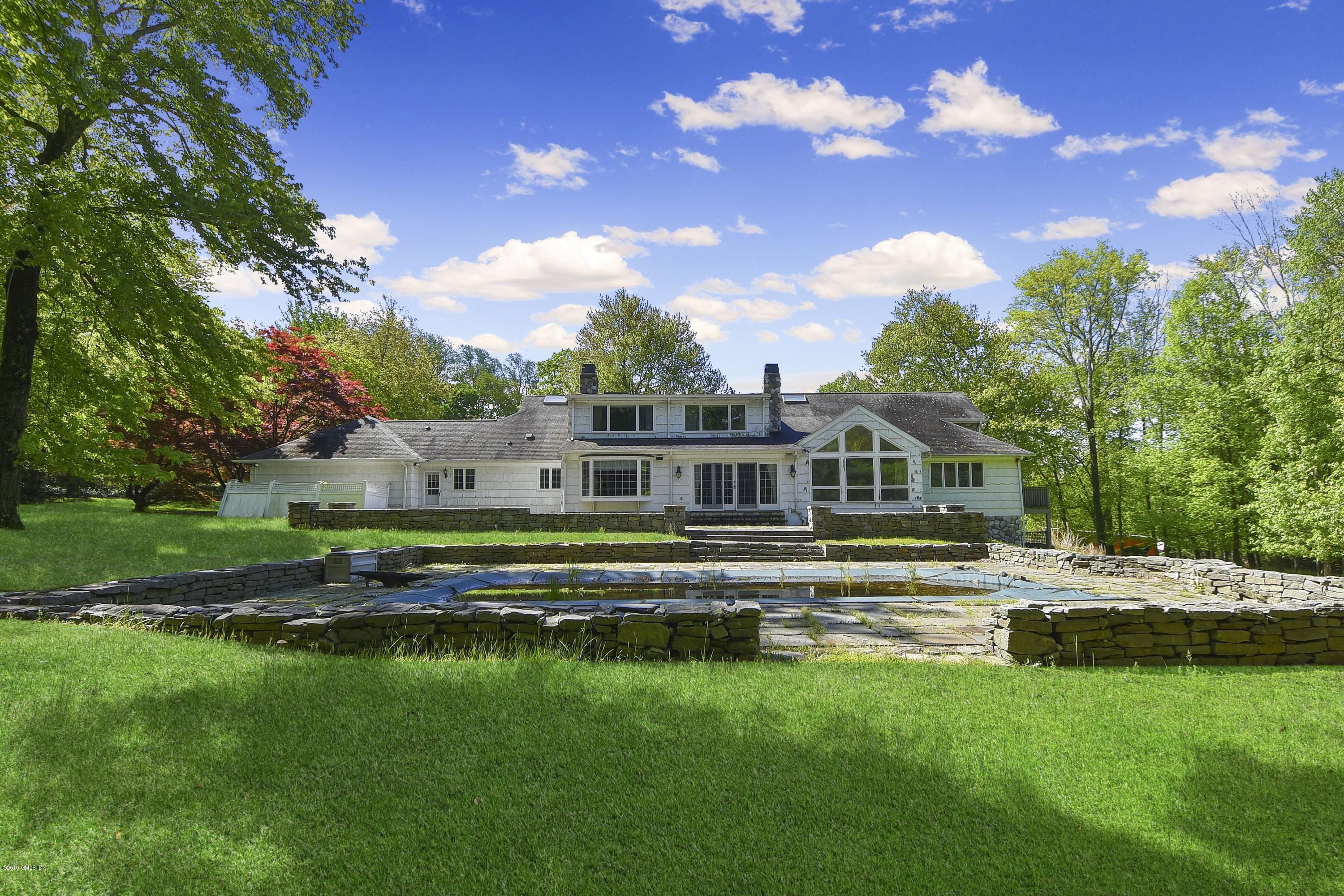 1 Tinker Lane Greenwich, CT 06830 - Photo 29 of 30 a front view of a house with a garden