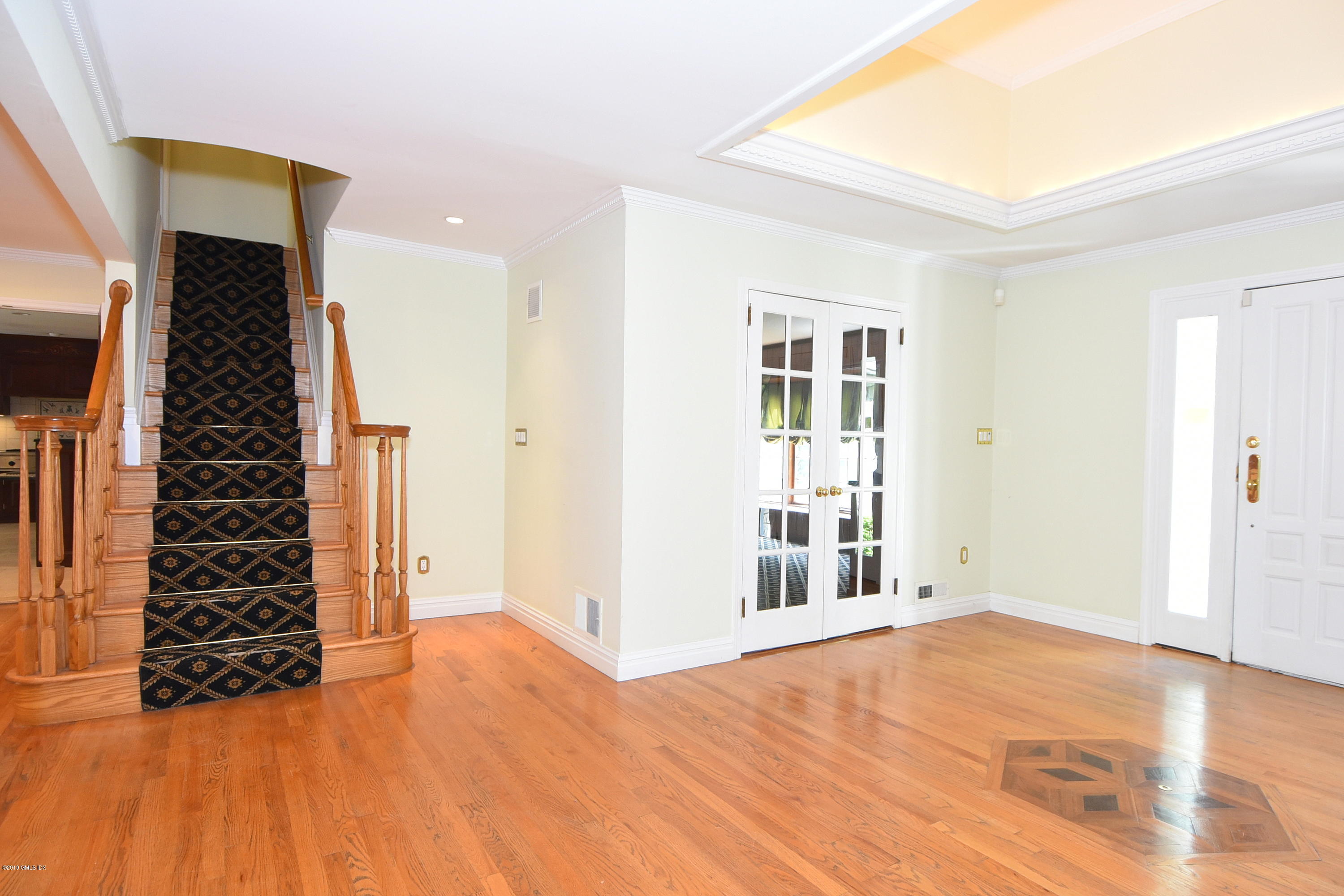 1 Tinker Lane Greenwich, CT 06830 - Photo 3 of 30 an empty room with wooden floor and windows