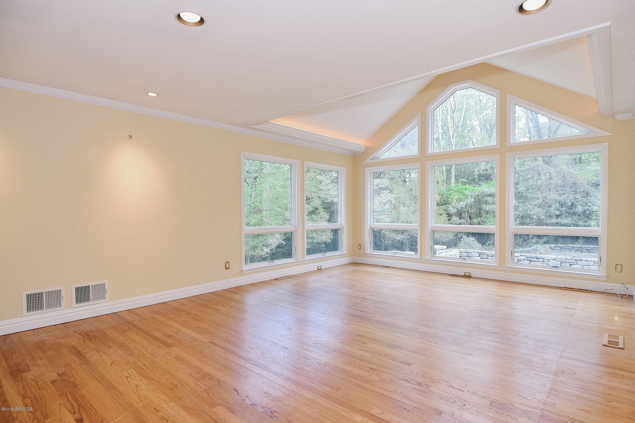 1 Tinker Lane Greenwich, CT 06830 - Photo 7 of 30 a view of an empty room with wooden floor and a window