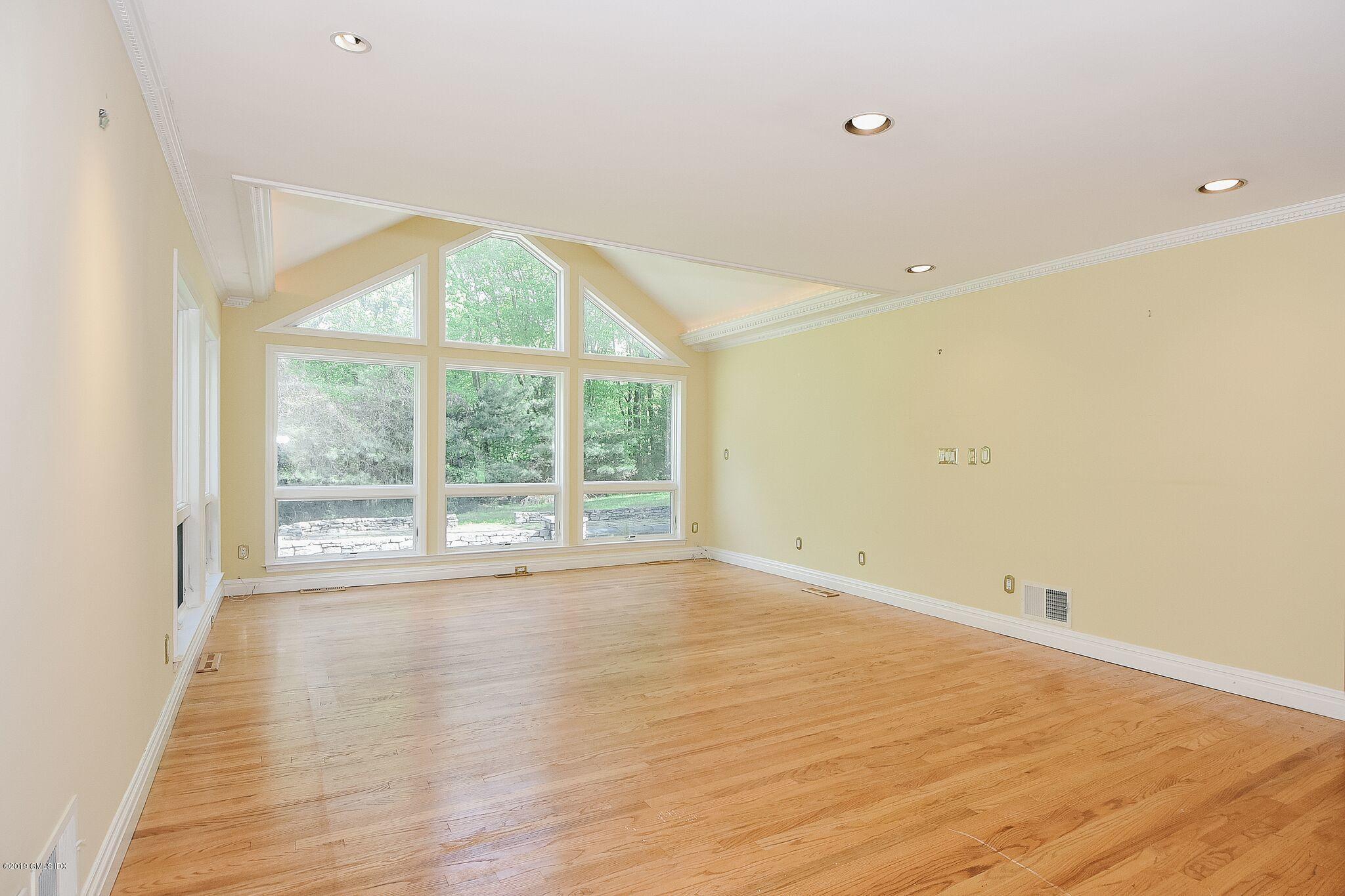1 Tinker Lane Greenwich, CT 06830 - Photo 8 of 30 a view of an empty room with wooden floor and a window