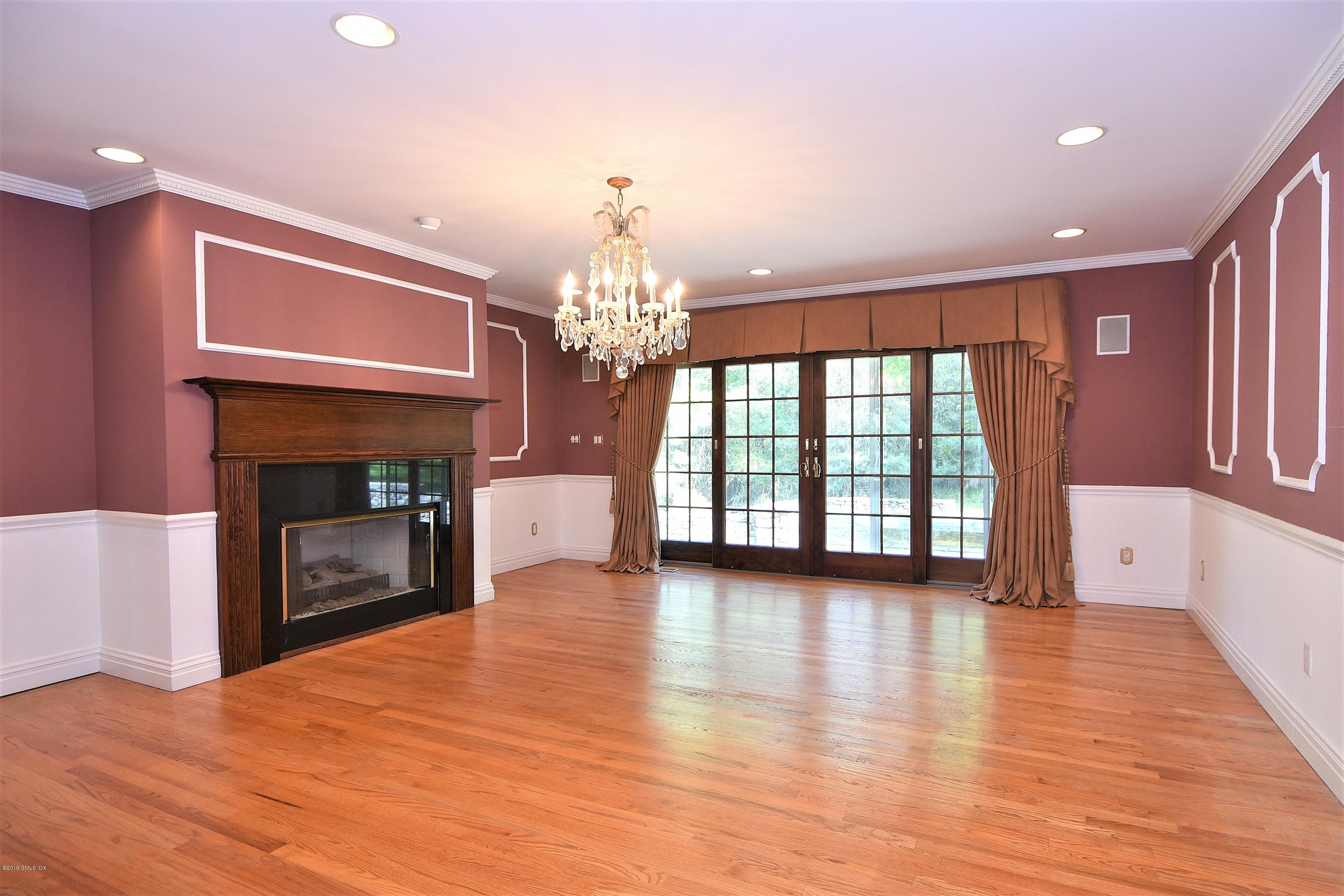 1 Tinker Lane Greenwich, CT 06830 - Photo 9 of 30 a view of an empty room with a fireplace and a window