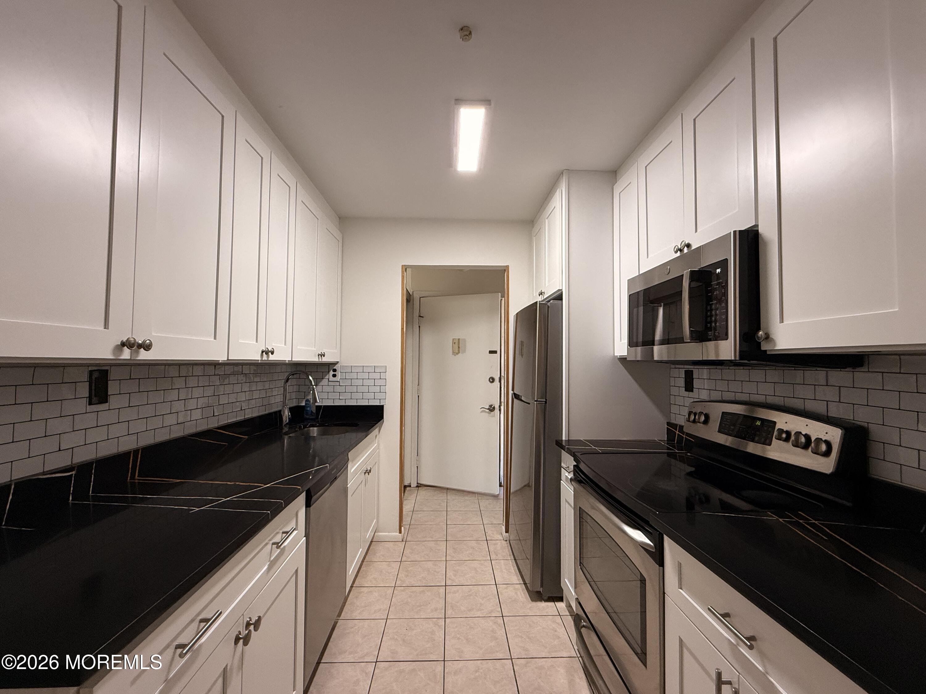 79 Overlook Way, Unit D Manalapan, NJ 07726 - Photo 2 of 13 a kitchen with granite countertop stainless steel appliances and cabinets