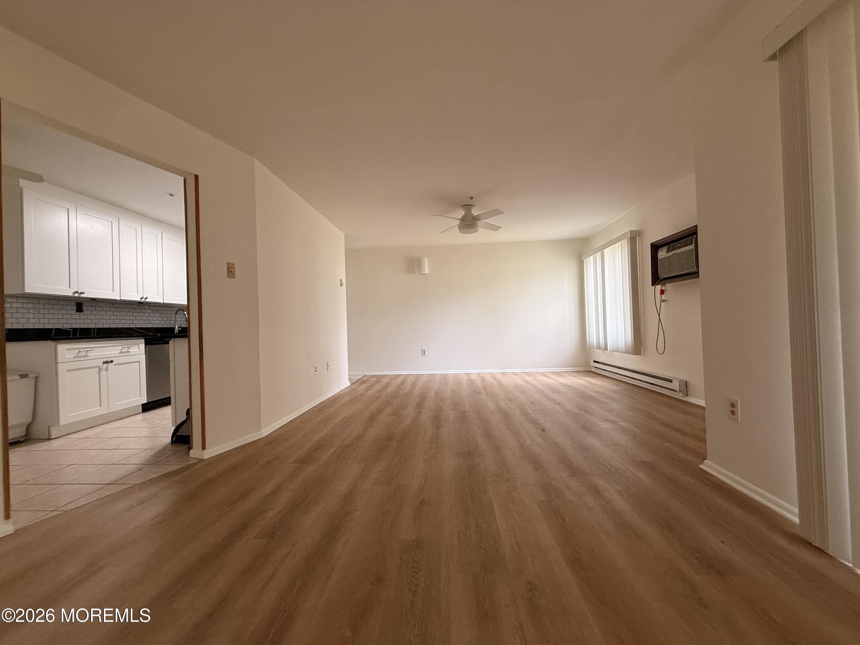 79 Overlook Way, Unit D Manalapan, NJ 07726 - Photo 6 of 13 a view of empty room with wooden floor