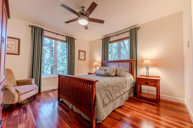 a living room with a bed furniture and a large window