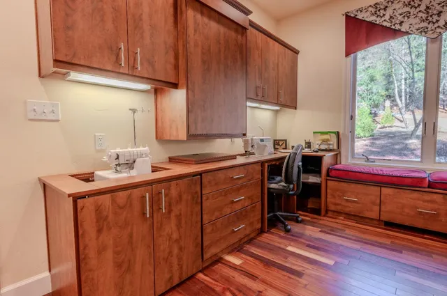 a bedroom with a bed and a table with wooden floor