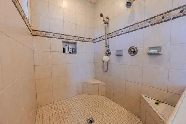 a bathroom with a granite countertop sink a toilet and shower