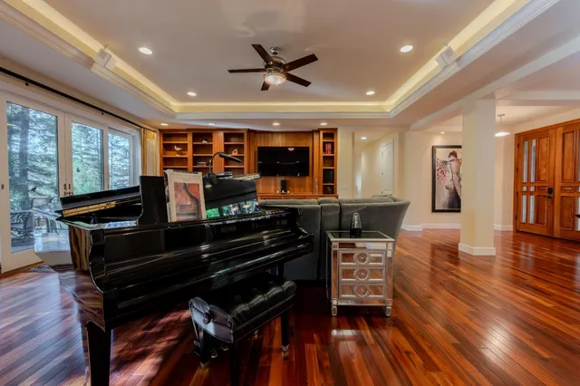 a living room with furniture and wooden floor