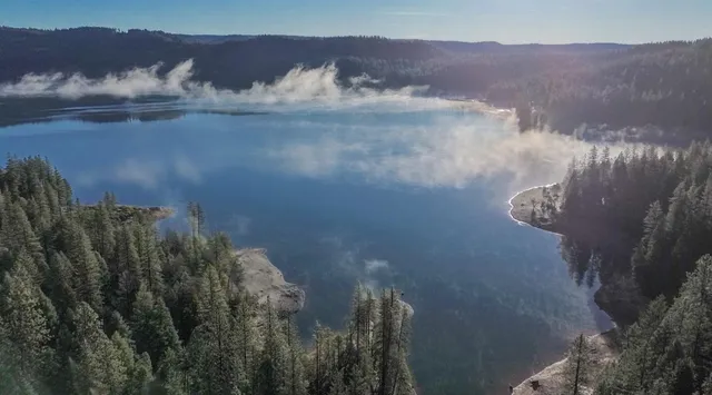 a living room with furniture tv and a flat screen tv
