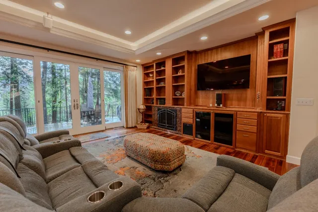 a living room with furniture wooden floor and a view of kitchen