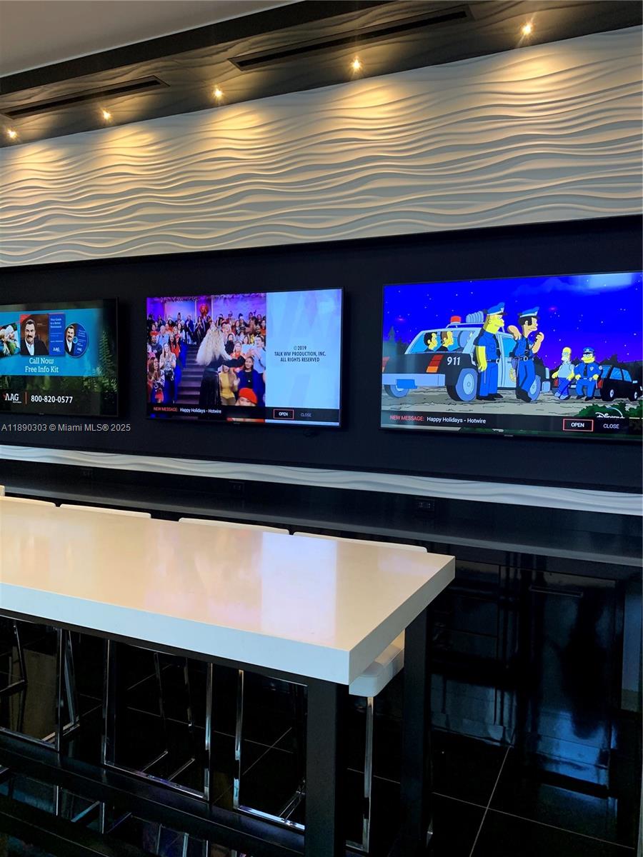 851 Northeast 1st Avenue, Unit 2702 Miami, FL 33132 - Photo 22 of 48 a room with red wall paintings and a wall painting