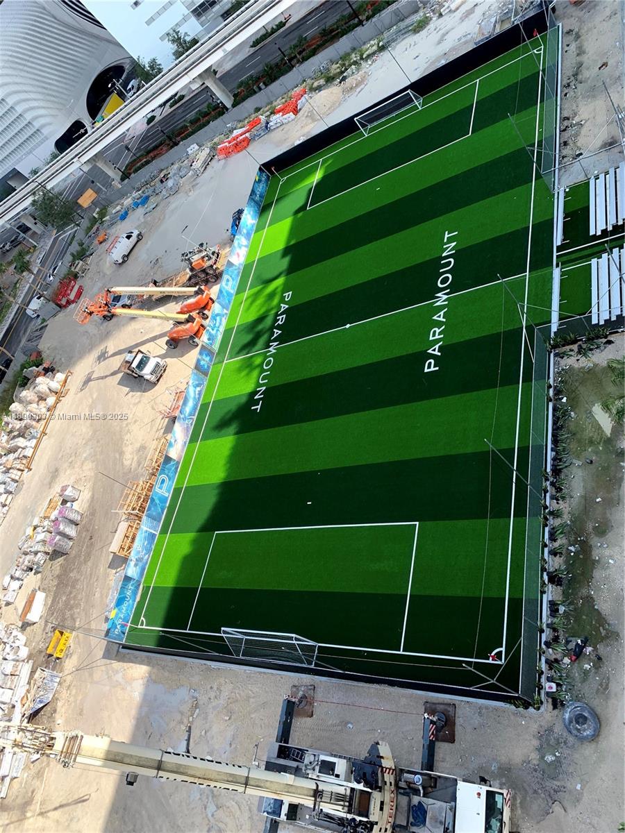 851 Northeast 1st Avenue, Unit 2702 Miami, FL 33132 - Photo 28 of 48 a view of a tennis ground with a wooden fence