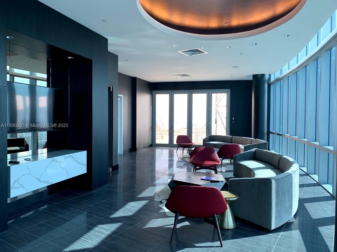 851 Northeast 1st Avenue, Unit 2702 Miami, FL 33132 - Photo 43 of 48 a living room with furniture and a potted plant