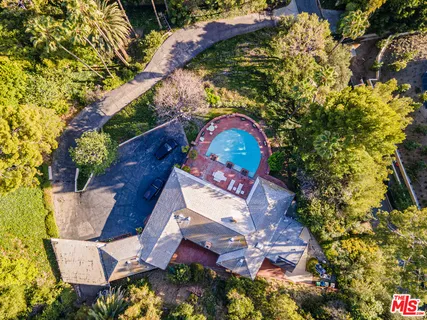 an aerial view of residential house with outdoor space and swimming pool