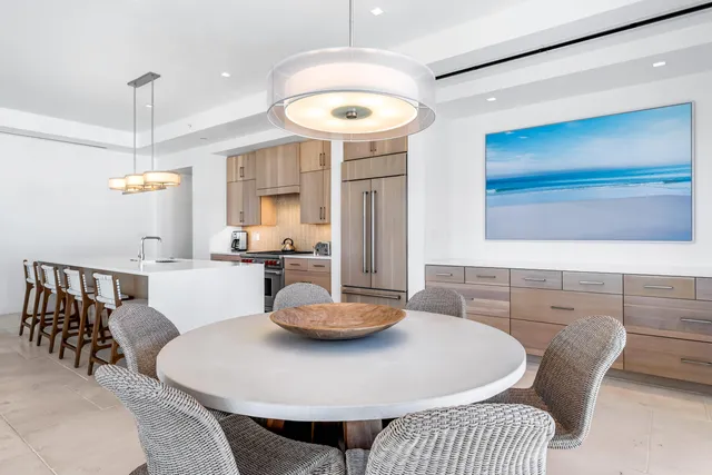 a large kitchen with a table and chairs