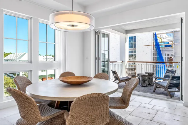 a dining room with furniture and a window