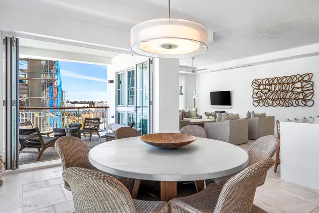 a dining room with furniture a chandelier and wooden floor