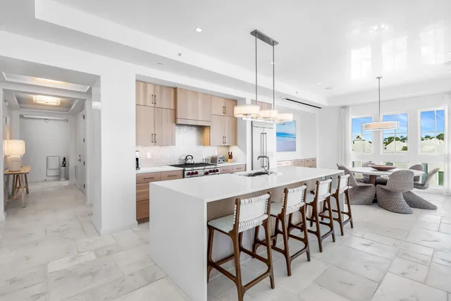 a large kitchen with a table and chairs