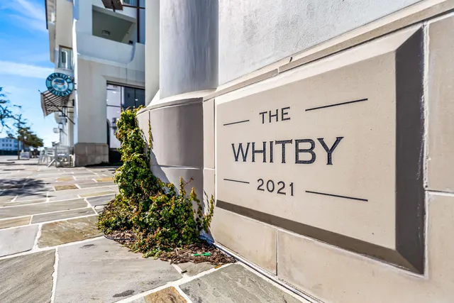 a view of a patio with a table and chairs and potted plants
