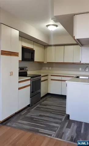 a kitchen with a sink cabinets and stainless steel appliances