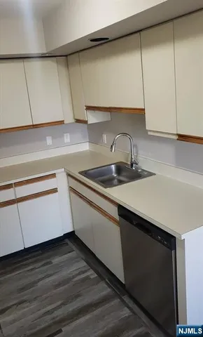 a kitchen with a sink and cabinets