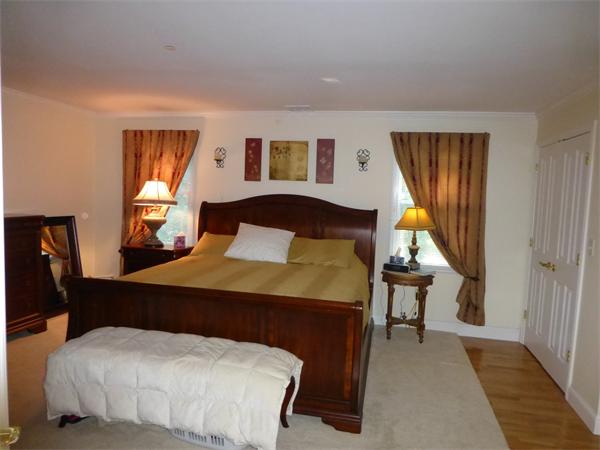 218 Rangeway Road, Unit 274 Billerica, MA 01862 - Photo 14 of 27 a bedroom with a bed and wooden floor