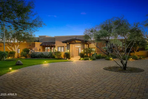 a view of residential houses with a yard and outdoor seating