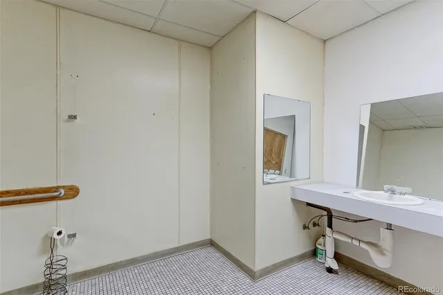 a bathroom with a sink a mirror and a vanity