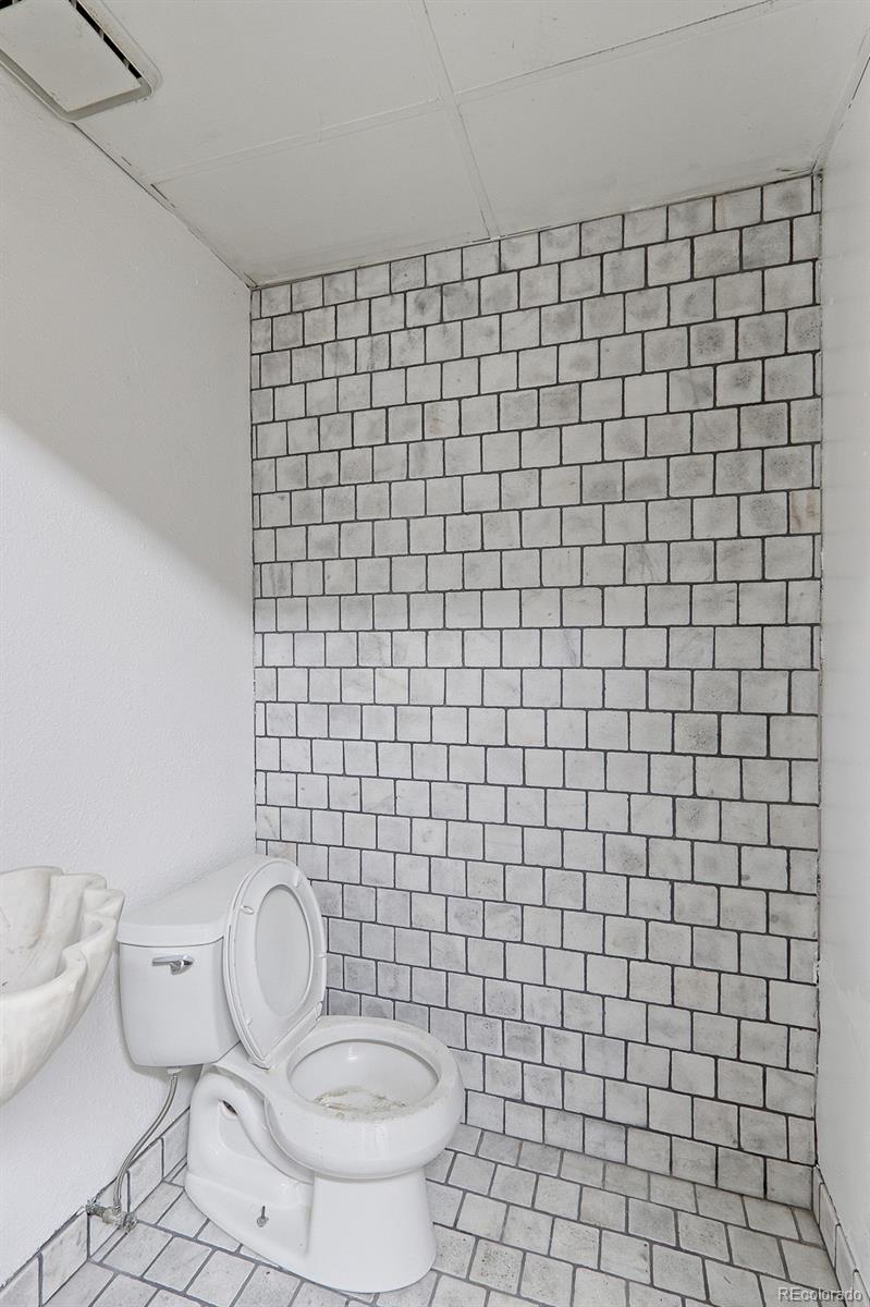 608 Cedar Street Hudson, CO 80642 - Photo 13 of 15 a bathroom with a toilet and a sink