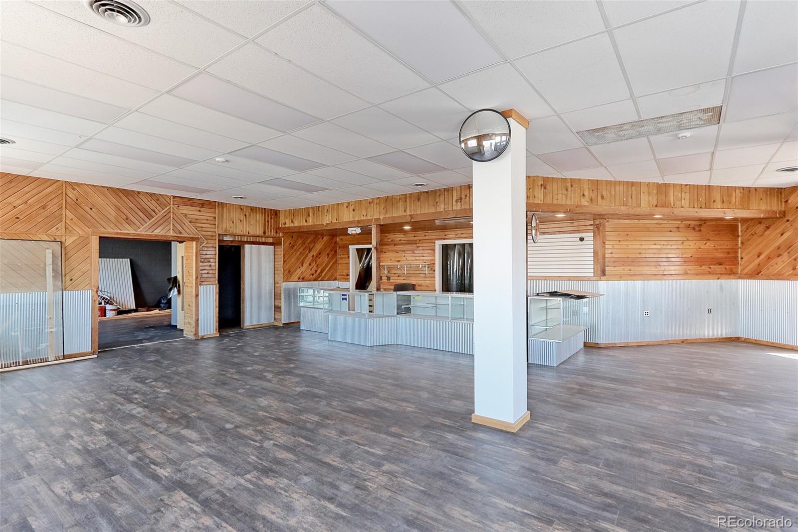 608 Cedar Street Hudson, CO 80642 - Photo 4 of 15 a view of a hallway with wooden floor