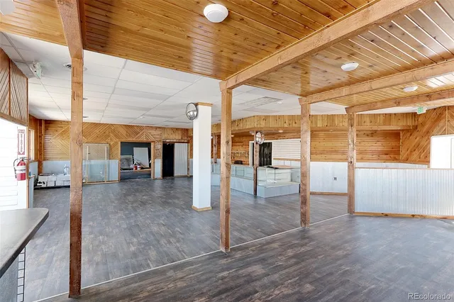 a view of a hall with wooden floor