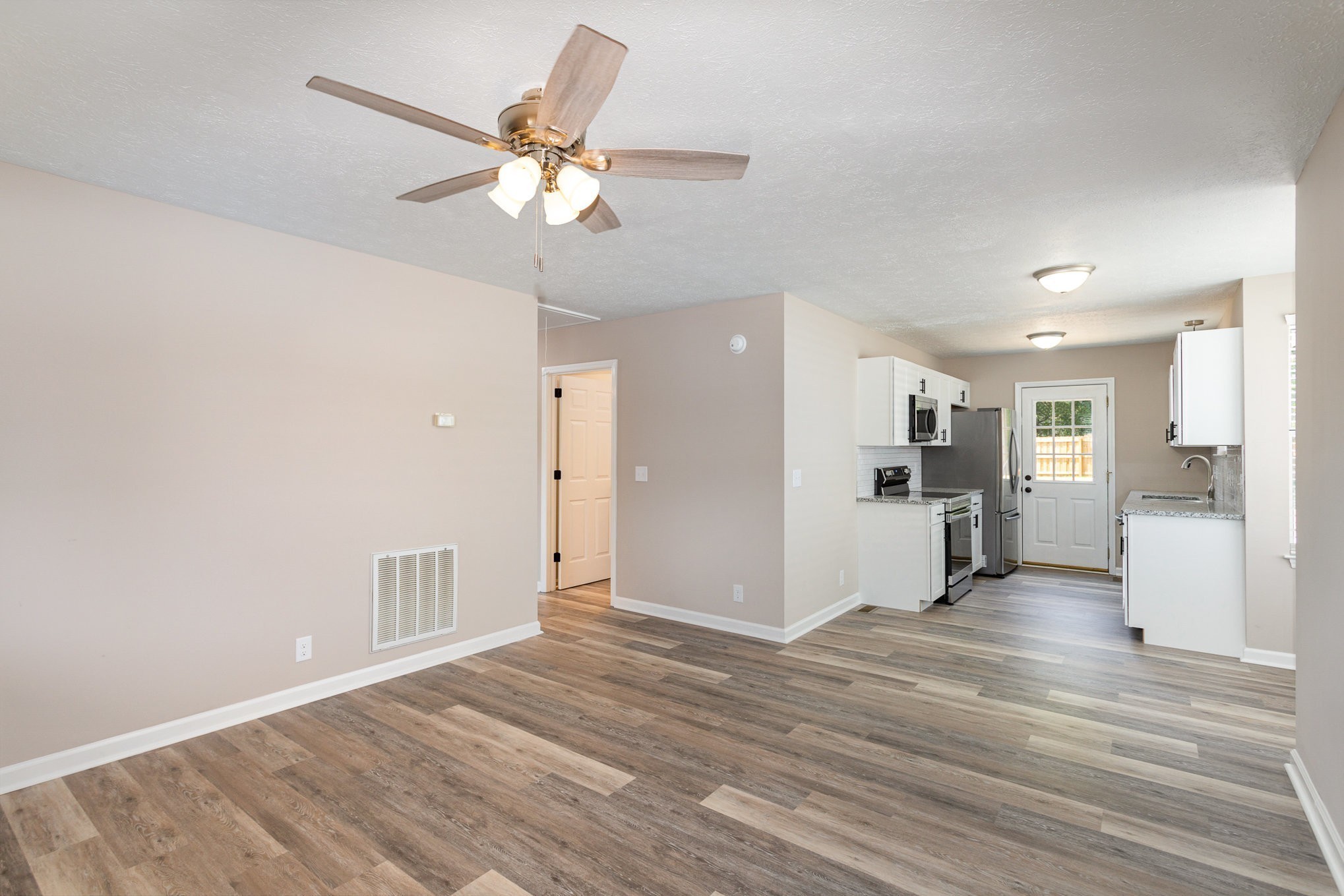 217 Maple Street Madison, TN 37115 - Photo 13 of 44 a view of a livingroom with wooden floor and a ceiling fan