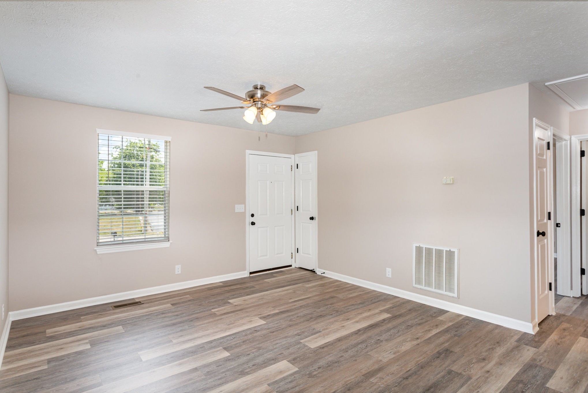 217 Maple Street Madison, TN 37115 - Photo 18 of 44 a view of an empty room with wooden floor and a window