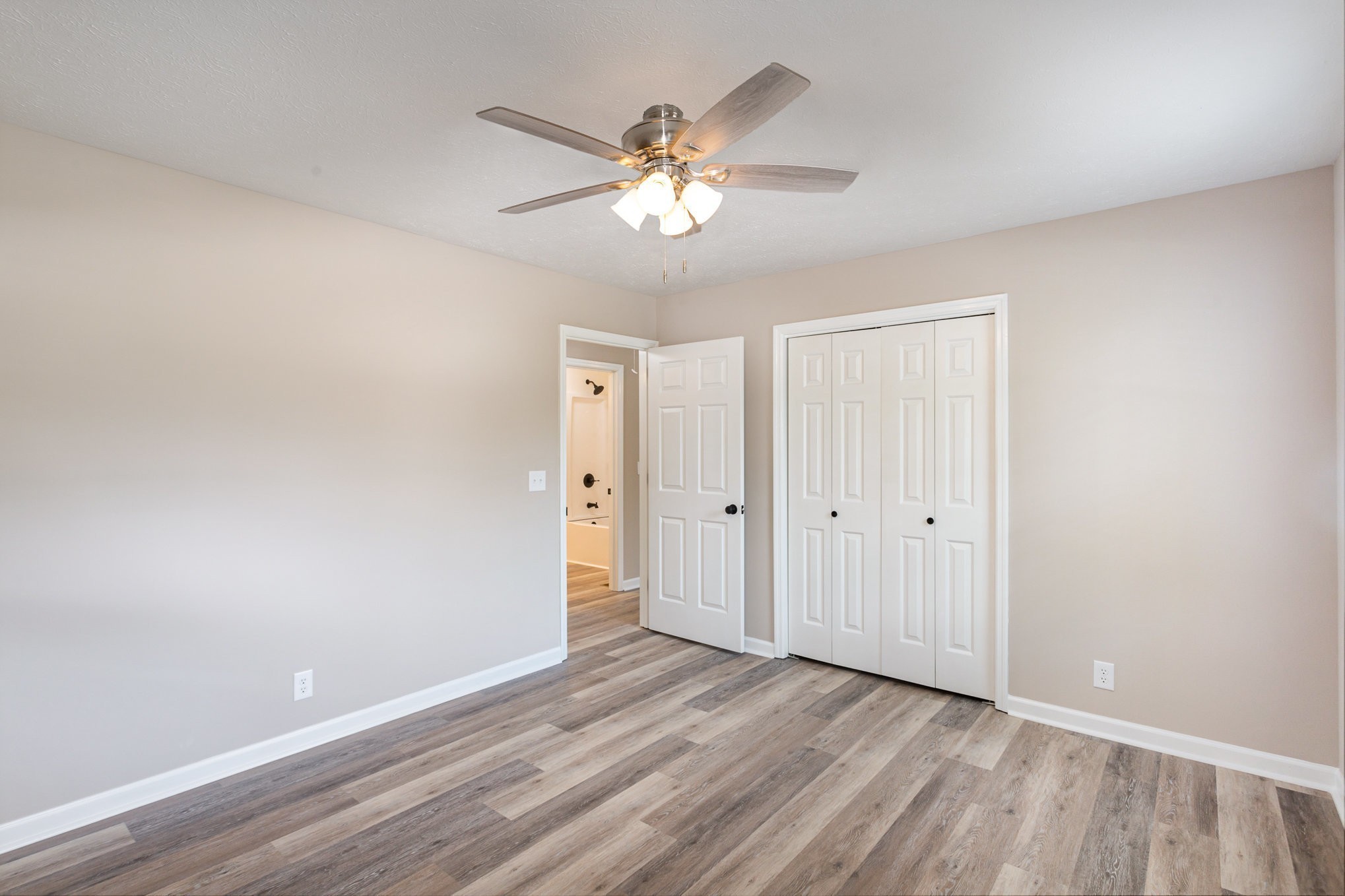 217 Maple Street Madison, TN 37115 - Photo 26 of 44 a view of an empty room with wooden floor and a ceiling fan