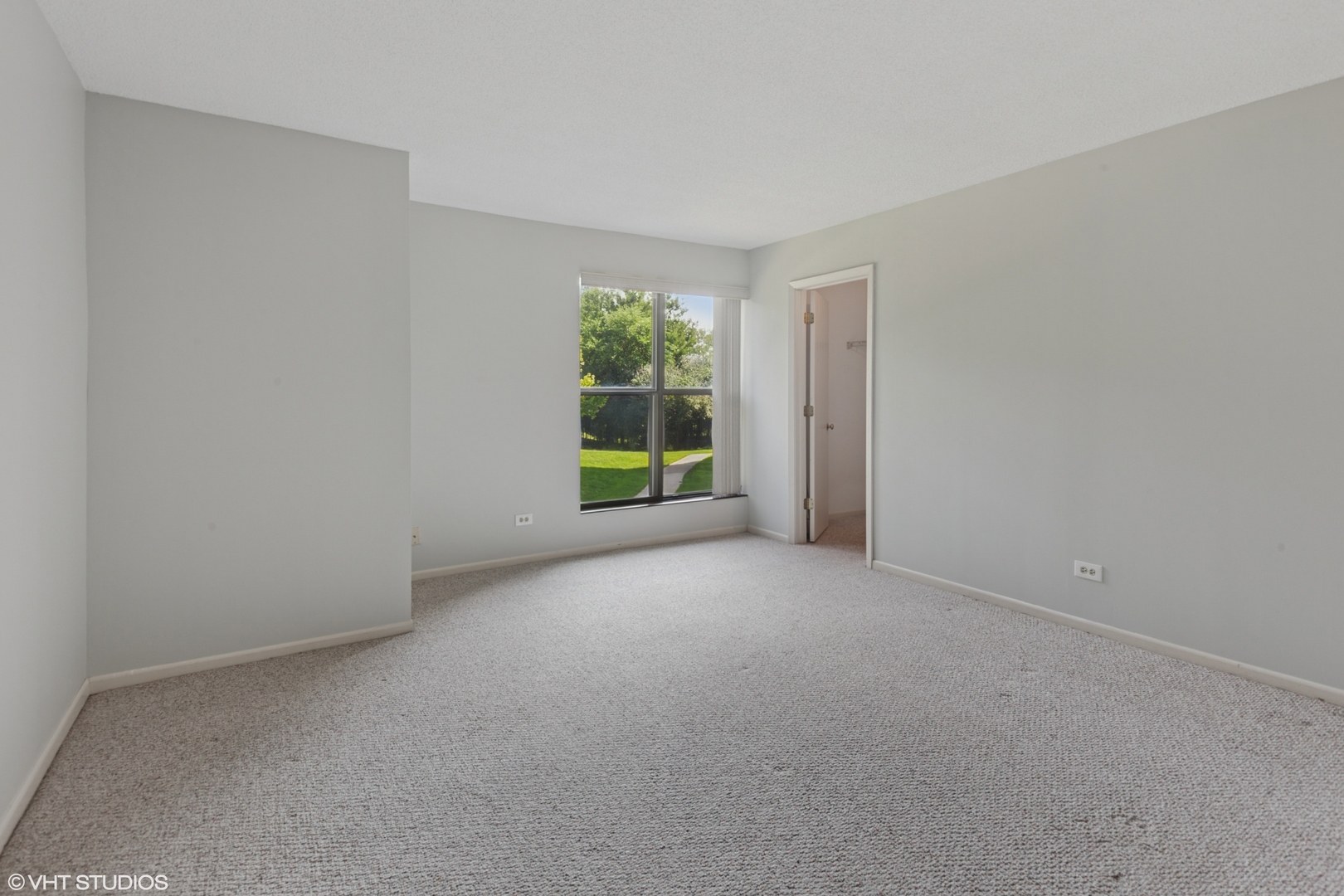 511 Aurora Avenue, Unit 108 Naperville, IL 60540 - Photo 11 of 32 a view of a big room with windows and closet