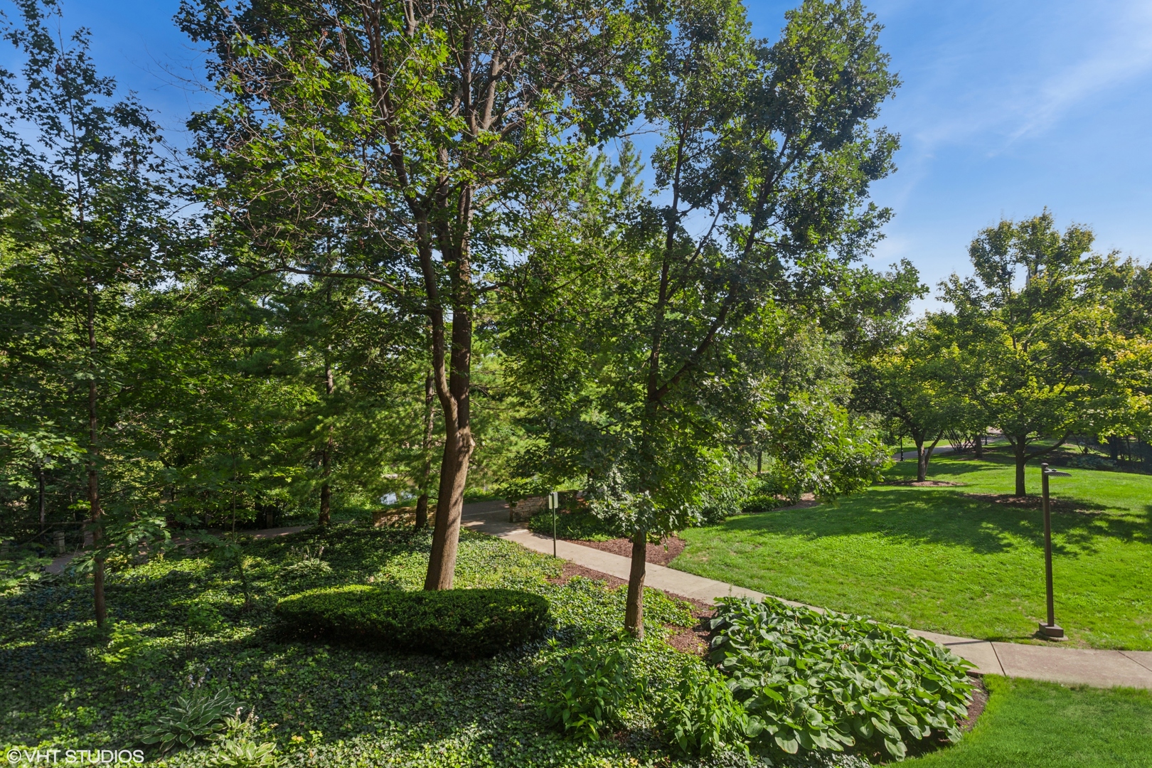 511 Aurora Avenue, Unit 108 Naperville, IL 60540 - Photo 30 of 32 a view of a garden with a tree