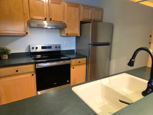 a kitchen with a refrigerator and cabinets