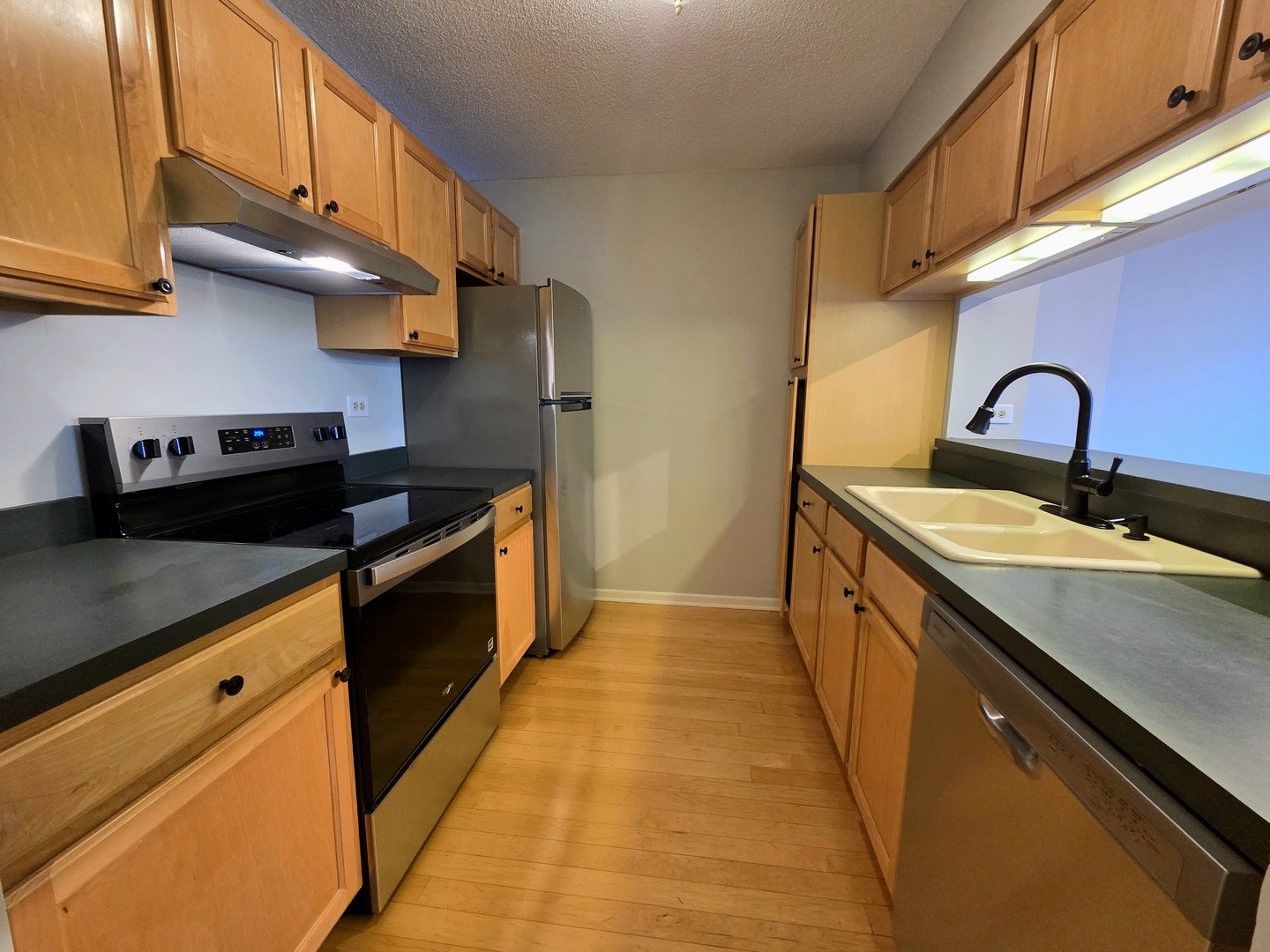 511 Aurora Avenue, Unit 108 Naperville, IL 60540 - Photo 8 of 32 a kitchen with stainless steel appliances granite countertop a sink a stove and a refrigerator